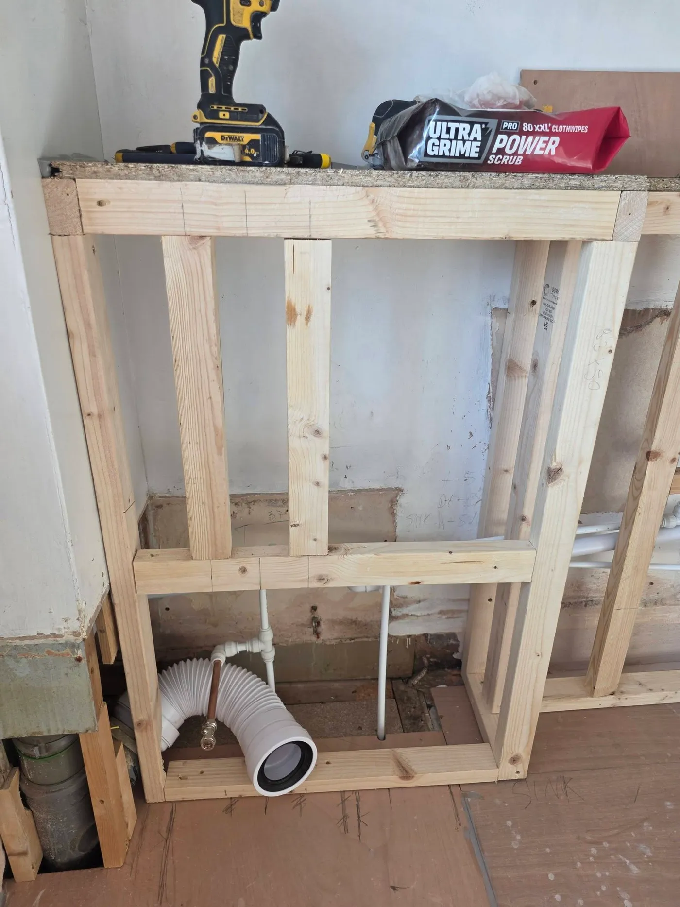 Timber framework built around the bathroom pipework.