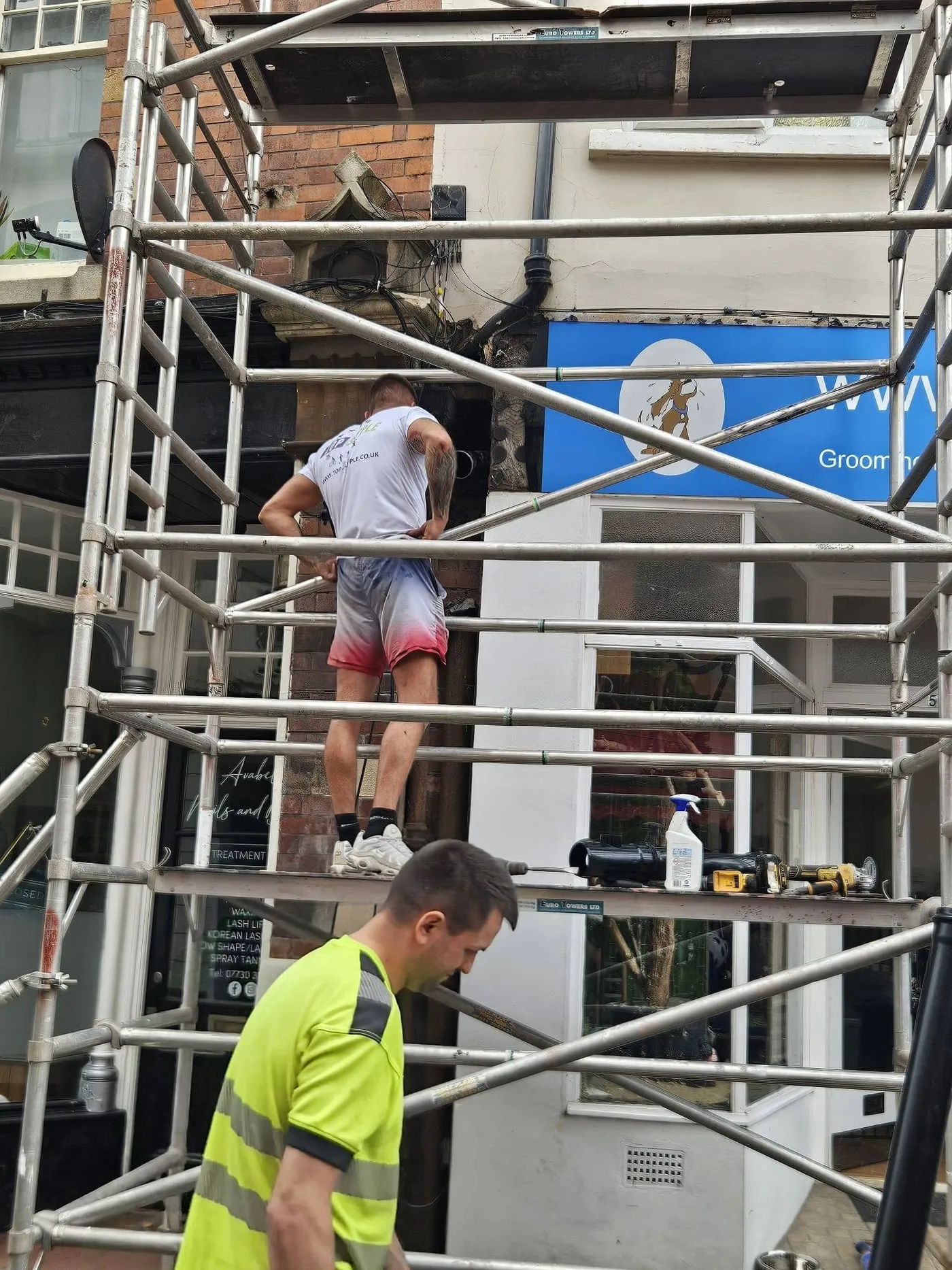 Exterior work in progress with scaffolding in place.