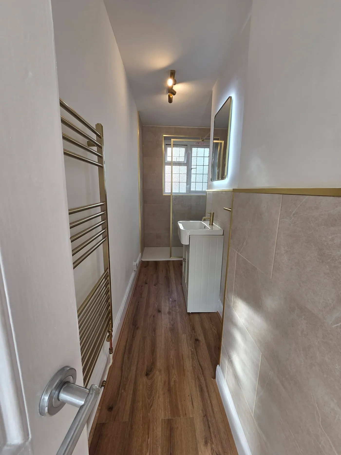 The finished bathroom approach, showing flooring and wall finishes.